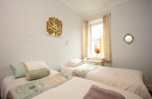 a bedroom with two beds and a window at Seascape in Whitley Bay