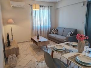 a living room with a couch and a table at Blue Yard Apartments in Kalamata