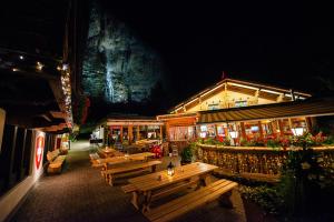 a group of wooden benches in front of a building at Camping Jungfrau in Lauterbrunnen