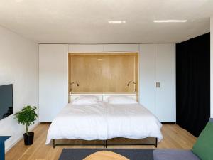 Säng eller sängar i ett rum på Grüezi Laax Apartments