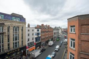 a view of a city street with buildings and cars at The Apache Hostel in Dublin