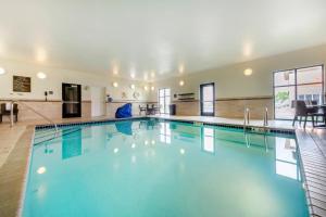 a large swimming pool in a building at Sleep Inn & Suites Devils Lake in Devils Lake