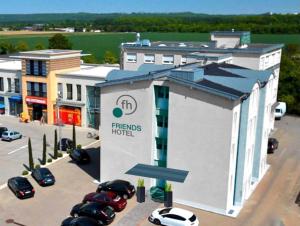 a rendering of a hotel with cars parked in a parking lot at Friends Hotel Kerpen in Kerpen