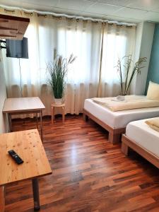 um quarto grande com duas camas e uma mesa em Easy Stay Rooms em Stuttgart