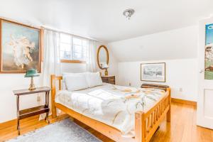 a bedroom with a bed and a painting on the wall at The Wilcox Cabin in Government Camp