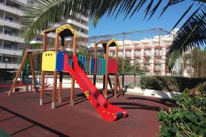 a playground with a red slide in a park at Carihuela Park Palace Studio in Torremolinos