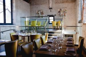 a dining room with tables and yellow chairs at The Archangel,Restaurant & Bar with Rooms in Frome