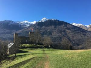a castle in a field with a mountain in the background at Appartement Solférino in Luz-Saint-Sauveur