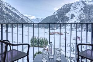 a balcony with a view of a snow covered mountain at Hotel Sant'Orso - Mountain Lodge & Spa in Cogne