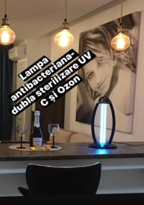 a room with a table with a blue light on it at Adams Apartment Onix Blue in Mamaia Sat/Năvodari