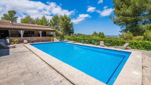 a swimming pool in the backyard of a house at Finca Es Collet in Felanitx