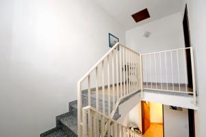 a staircase in a house with white walls at B&B L'Ormeggio in Monfalcone