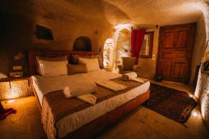 A bed or beds in a room at Prime Cappadocia Suites