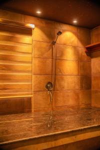 a shower with a shower head on a wall at Lifestyle18 Hotel and Shortlet Apartments in Lagos +23 photos