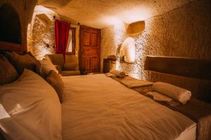 A bed or beds in a room at Prime Cappadocia Suites
