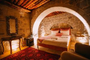 A bed or beds in a room at Prime Cappadocia Suites