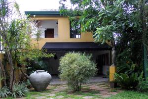 een huis met een grote vaas ervoor bij Villa Escondite - The Hotel in Sri Jayewardenepura Kotte