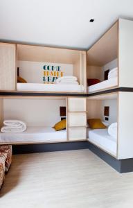 A bed or beds in a room at Toc Hostel Sevilla