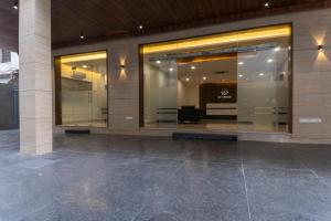 a lobby of a building with glass windows and a screen at Sky Ridge in Vijayawāda