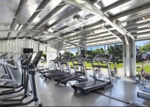 a gym with treadmills and elliptical machines at ALOHA - Poipu Beach Vacation Condo in Koloa