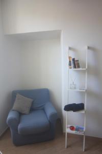 a blue couch in a room with a book shelf at Vernazza Vacation 2 in Vernazza