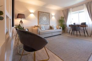 a living room with a couch and a table at BEACHOME4U3 in Carcavelos