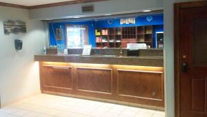 a bar in a restaurant with blue walls and brown cabinets at Motel 6 Myrtle Beach in Myrtle Beach