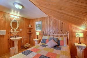 a bedroom with a bed and a sink in it at Les Gites Makadan in Normandin