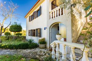 MilohnićiApartman Doris的白色的房子,设有门廊和楼梯