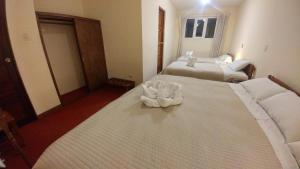 Postel nebo postele na pokoji v ubytování Hostal El Peregrino