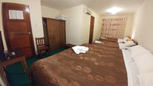 Postel nebo postele na pokoji v ubytování Hostal El Peregrino