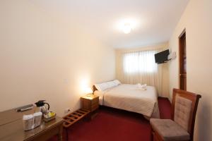 Postel nebo postele na pokoji v ubytování Hostal El Peregrino