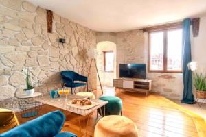a living room with a stone wall at Manoir Vue mer Parking free in Étretat