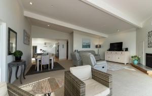 a living room with a couch and a table at Doubtless Bay Retreat 