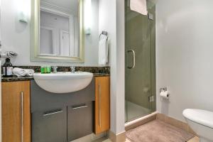 a bathroom with a sink and a shower at Ultimate outdoor-living Urban Getaway! 1 Carpark in Auckland +14 photos