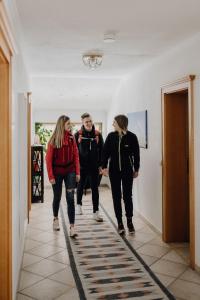 a group of people walking down a hallway at Dorfcafe Unken Hotelpension sWirtshaus im Dorf in Unken