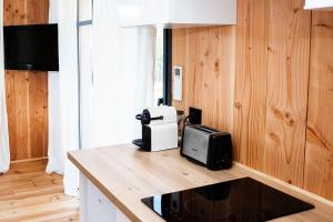a kitchen with a microwave and a toaster on a counter at Beach House in Lège-Cap-Ferret