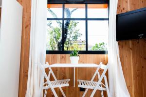 a room with a table and chairs and a window at Beach House in Lège-Cap-Ferret