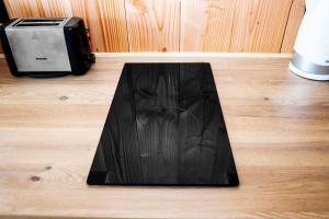 a black tray sitting on top of a wooden floor at Beach House in Lège-Cap-Ferret