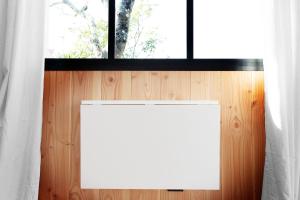 a window with a whiteboard in a room with a wooden wall at Beach House in Lège-Cap-Ferret