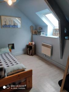 a bedroom with a bed and a window at Le Cati Mini in Cancale