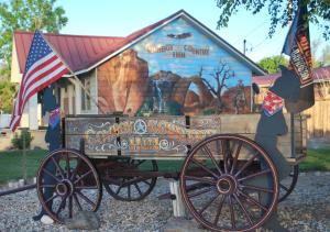 a horse drawn cart in front of a building at Cowboy Country Inn in Escalante