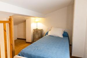 a small bedroom with a blue bed and a lamp at Résidence Marie Diane - Laurier des Montagnes in Propriano +10 photos