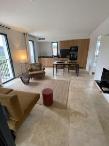 a living room with a couch and a table at Les Palivettes 2.1 in Malaucène