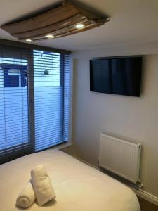 a bedroom with a bed with a towel on it at The Flying Scotsman Flamborough in Flamborough +24 photos