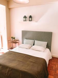 a bedroom with a large bed with two pillows at 7Rios Rooms in Lisbon