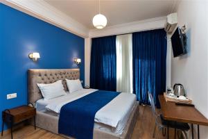 a blue bedroom with a bed with a blue wall at B&B Old Tbilisi in Tbilisi City