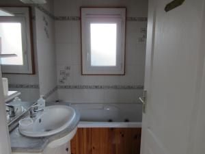 a bathroom with a sink and a bath tub at Maison LES SABLES D'OLONNE 700 m Plage WIFI in La Pironnière +8 photos