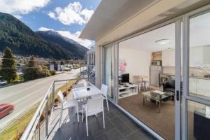 an apartment balcony with a view of the mountains at Mountain View City Apartment in Queenstown