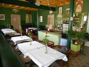 a row of tables in a restaurant with flowers on them at Johan's Lodge in Zwalm